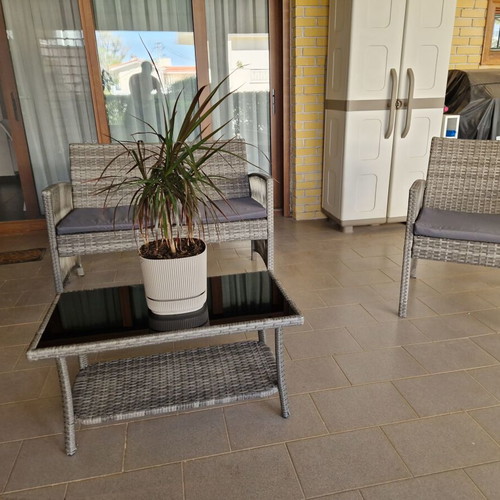 Garden sofa set with cushions and table