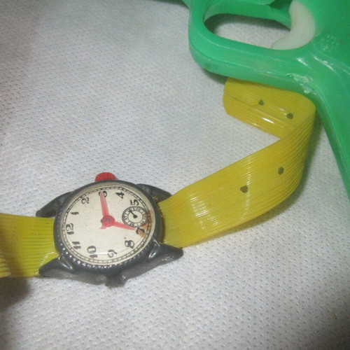 Plastic toys from the 70s like new pistol, flashlight, watch, spinning tops