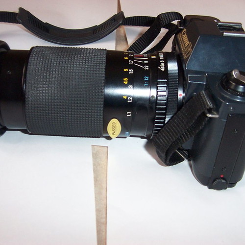 Canon T50 SLR analog camera used with two zoom lenses and flash