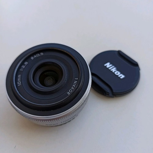 Nikon 1 NIKKOR 10mm f/2.8 lens used, silver compact prime