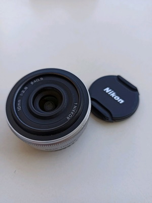 Nikon 1 NIKKOR 10mm f/2.8 lens used, silver compact prime