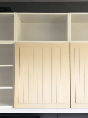 Wall-mounted shelving unit used, adjustable shelves, white