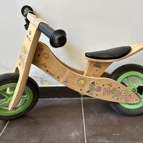 Wooden children's balance bike with extra rear wheel