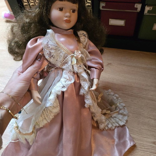 Glass doll like new with satin rotten apple dress and hat