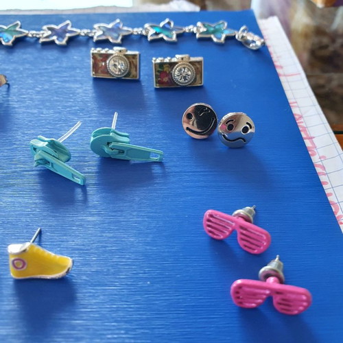 Unique earrings used with designs of swimsuits, rackets, sunglasses