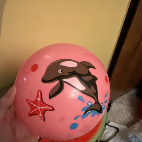 Pink inflatable beach ball with dolphin design