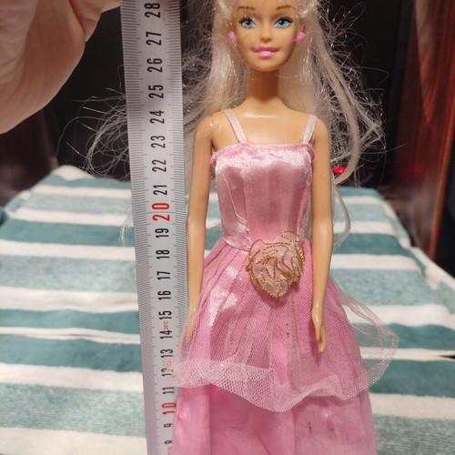 Barbie doll used with dress tears