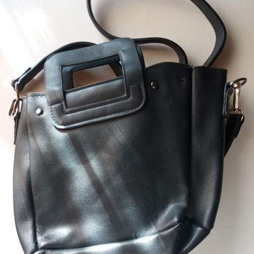 Black Women's Shoulder Bag like new with laser-cut patterns and tassels