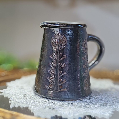 Retro ceramic milk jug with embossed flowers