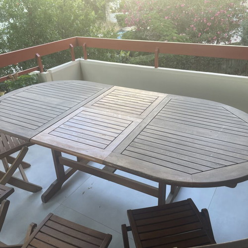 Wooden balcony table with four chairs used