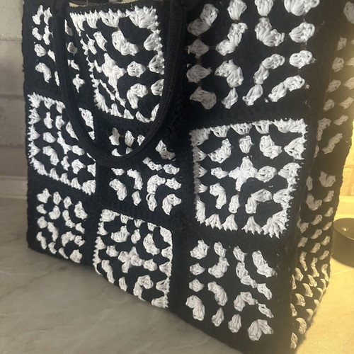 Handmade jute bag with black and white crochet motifs
