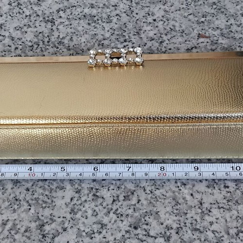 Gold evening clutch bag with rhinestones and metal frame