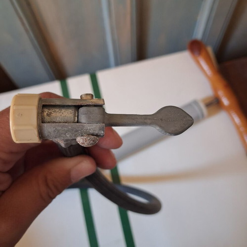 Manual air pump used with wooden handle and flexible hose