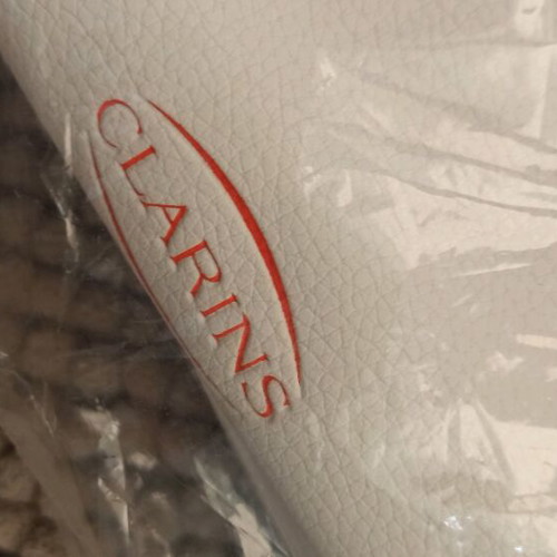 Clarins cosmetic bag new, white with striped handles