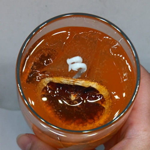 Handmade candle in Aperol Spritz glass with Aperol Spritz scent