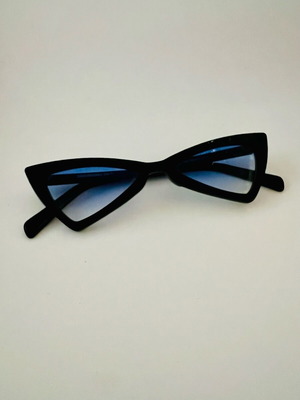 Glasses with blue triangular lens used, black frame