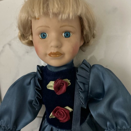 Porcelain doll like new vintage with blue satin dress