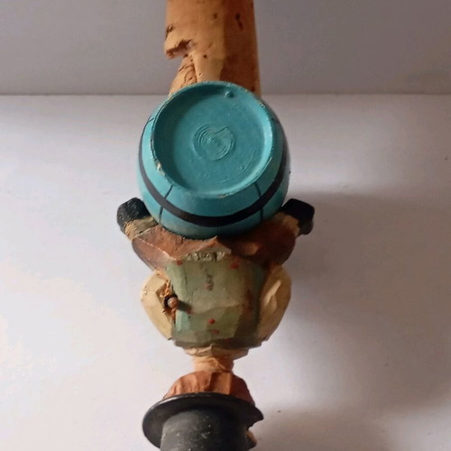 Cork used with carved wooden bottle stopper and boy figure