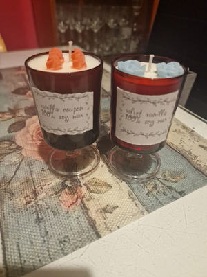 Handmade scented candle with vanilla aroma in elegant burgundy glass