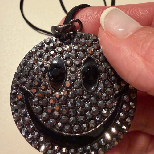 Long pendant like new with decorative emoji and black rhinestones