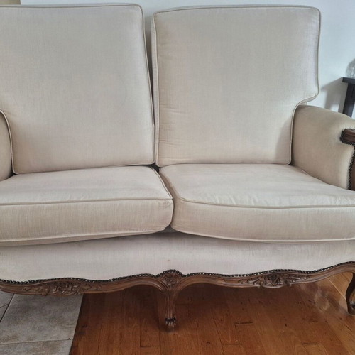 Handmade carved walnut loveseat with cream velvet fabric