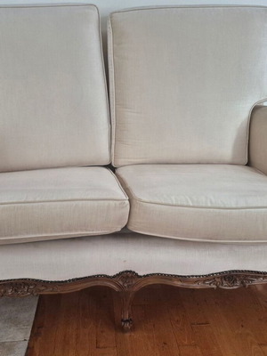 Handmade carved walnut loveseat with cream velvet fabric