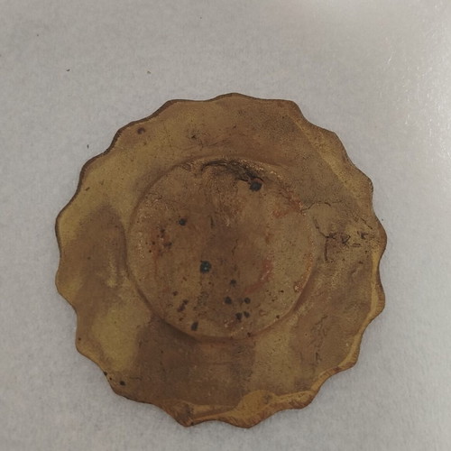 Small vintage brass object used with carved figure