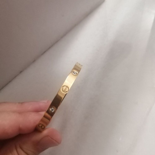 Steel bracelet with clip and rhinestones, gold color