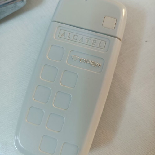Alcatel mobile phone used, non-functional, with original charger