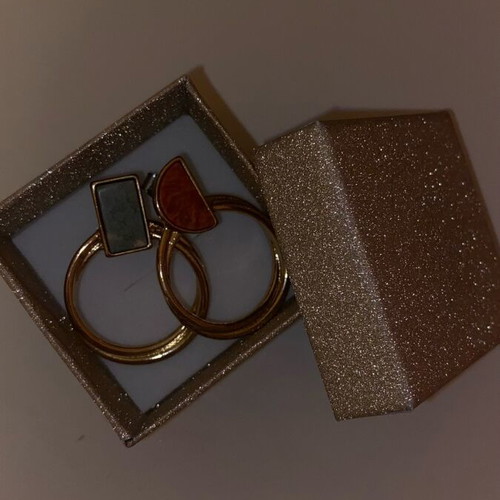 Gold hoop earrings used with detail on top part