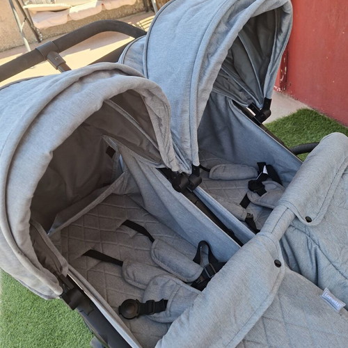 Double stroller for twins or close-aged children with footmuffs and bag