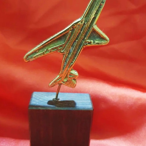 Decorative miniature warplane used on wooden base