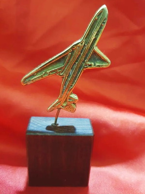 Decorative miniature warplane used on wooden base