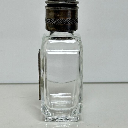 Vintage glass perfume bottle with metal decoration