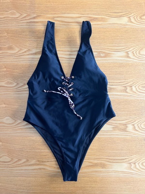 Black one-piece swimsuit with animal print cord, size L, like new