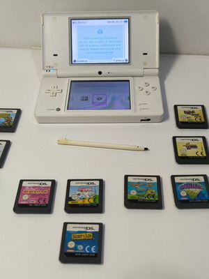 Nintendo DSi white console with 10 games and stylus used