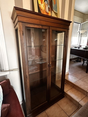 Wooden display cabinet with glass doors and shelves