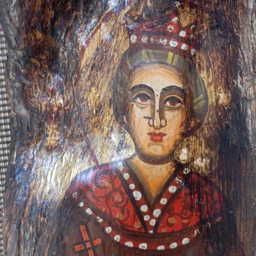 Old religious icon on wood trunk, handmade