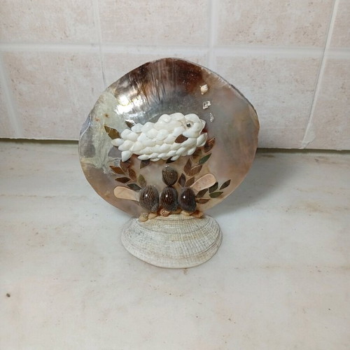 Handmade table decoration with fish made of natural shells like new