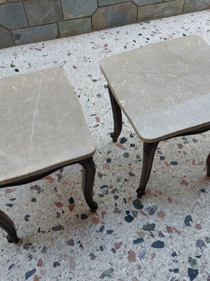 Vintage side tables pair with natural marble used