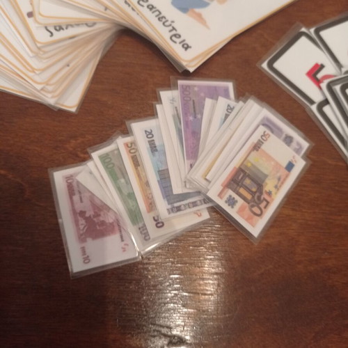 Educational laminated cards with alphabet, money, and numbers