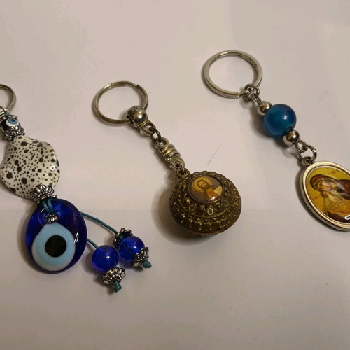 Set of 3 keychains like new with Meteora, evil eye and religious images