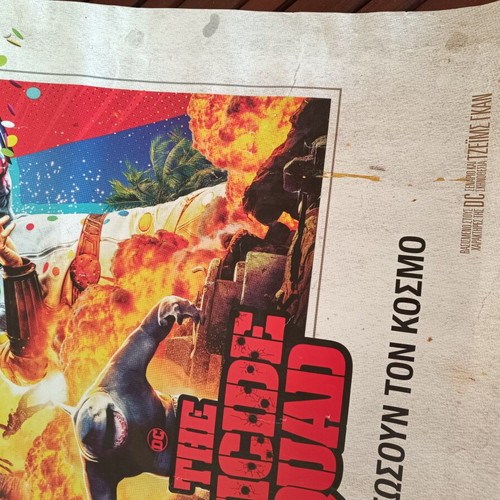 The Suicide Squad movie poster used with visible wear
