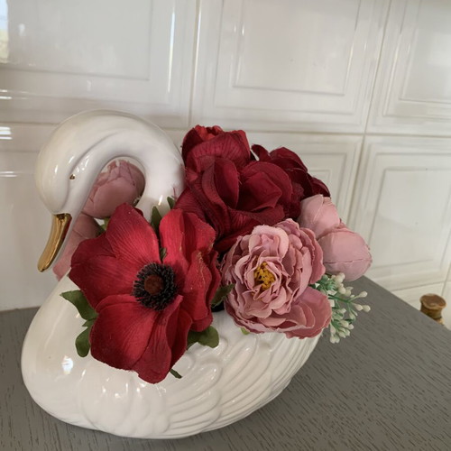 Vintage ceramic swan pair with glossy white finish and gold beak