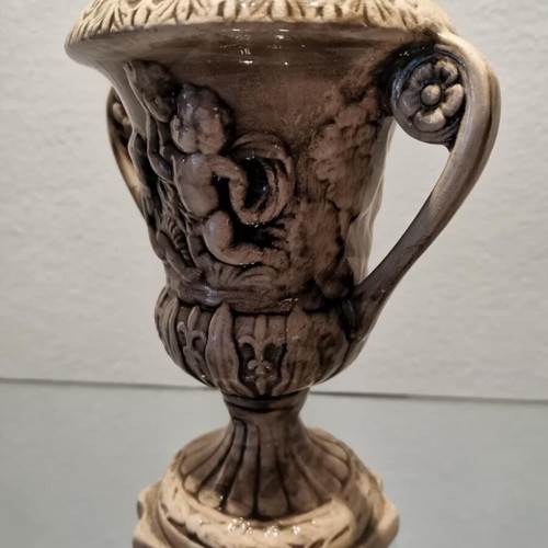 Faience amphora used with embossed design and cupids