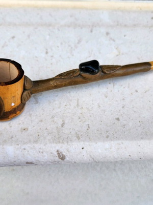 Carved pipe used, moderate condition