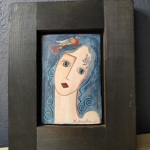 Vintage ceramic tile portrait of a woman with wooden frame used