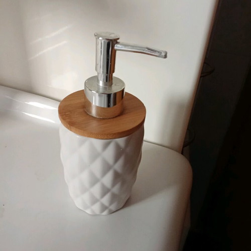 Soap dispenser like new with white ceramic body and bamboo lid