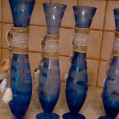 Glass vase decorated with natural shells like new