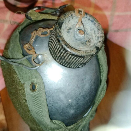 Brodie Mark 11 British helmet and canteen from World War II used